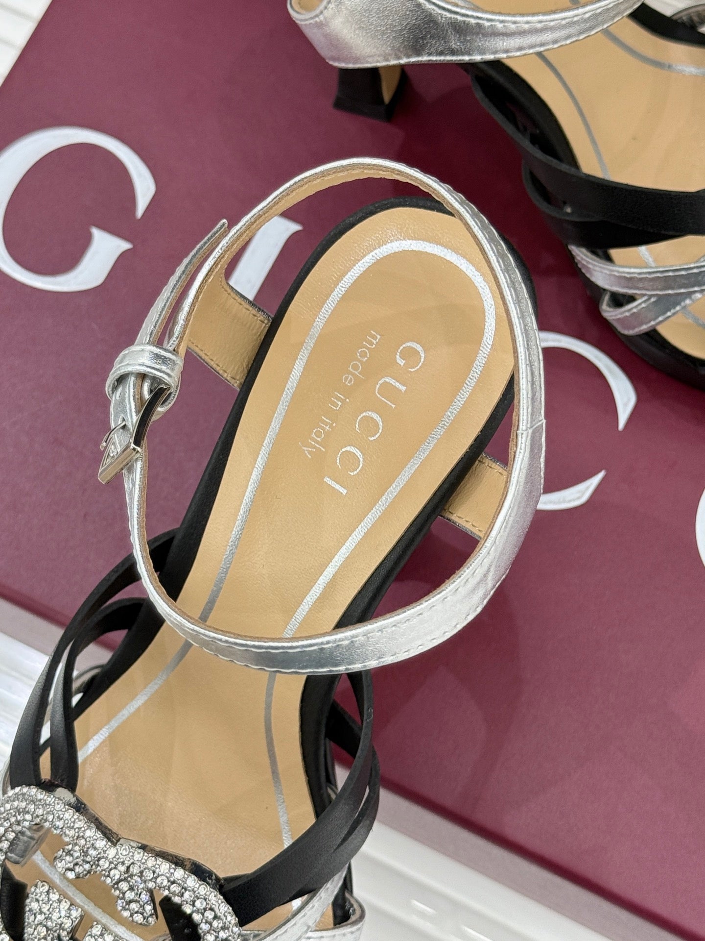 Gucci heeled sandal with silver ankle strap and transparent sole detailing, on black base