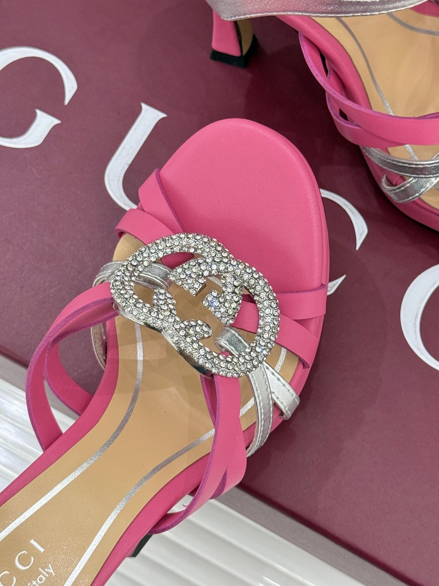 Gucci ladies heeled sandal close-up, pink straps with rhinestone heart buckle on vamp