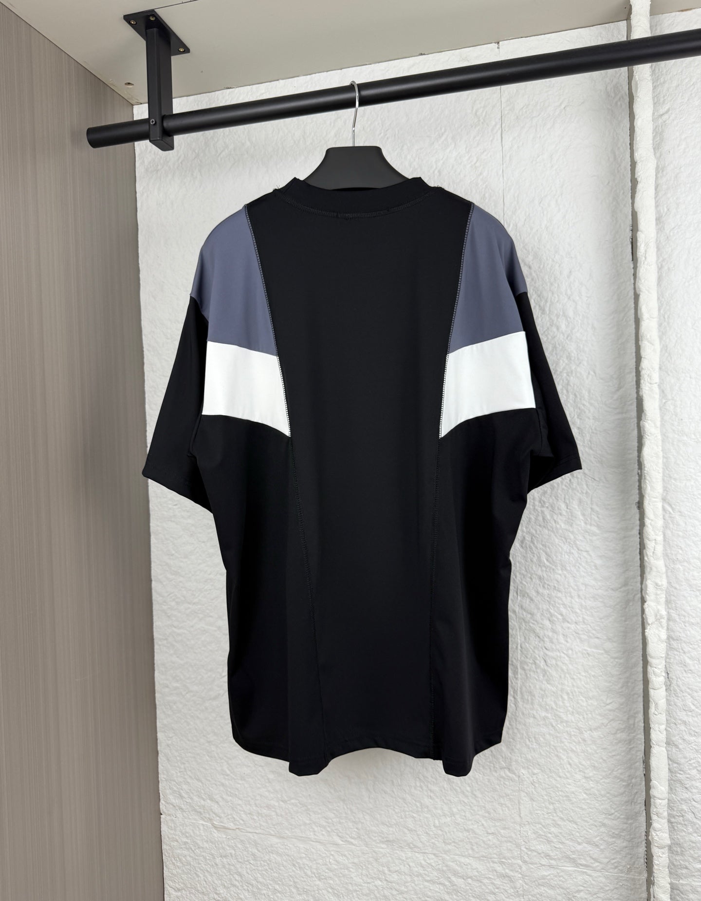 Louis Vuitton short-sleeve T-shirt, back view with black body and blue/white chevron panel