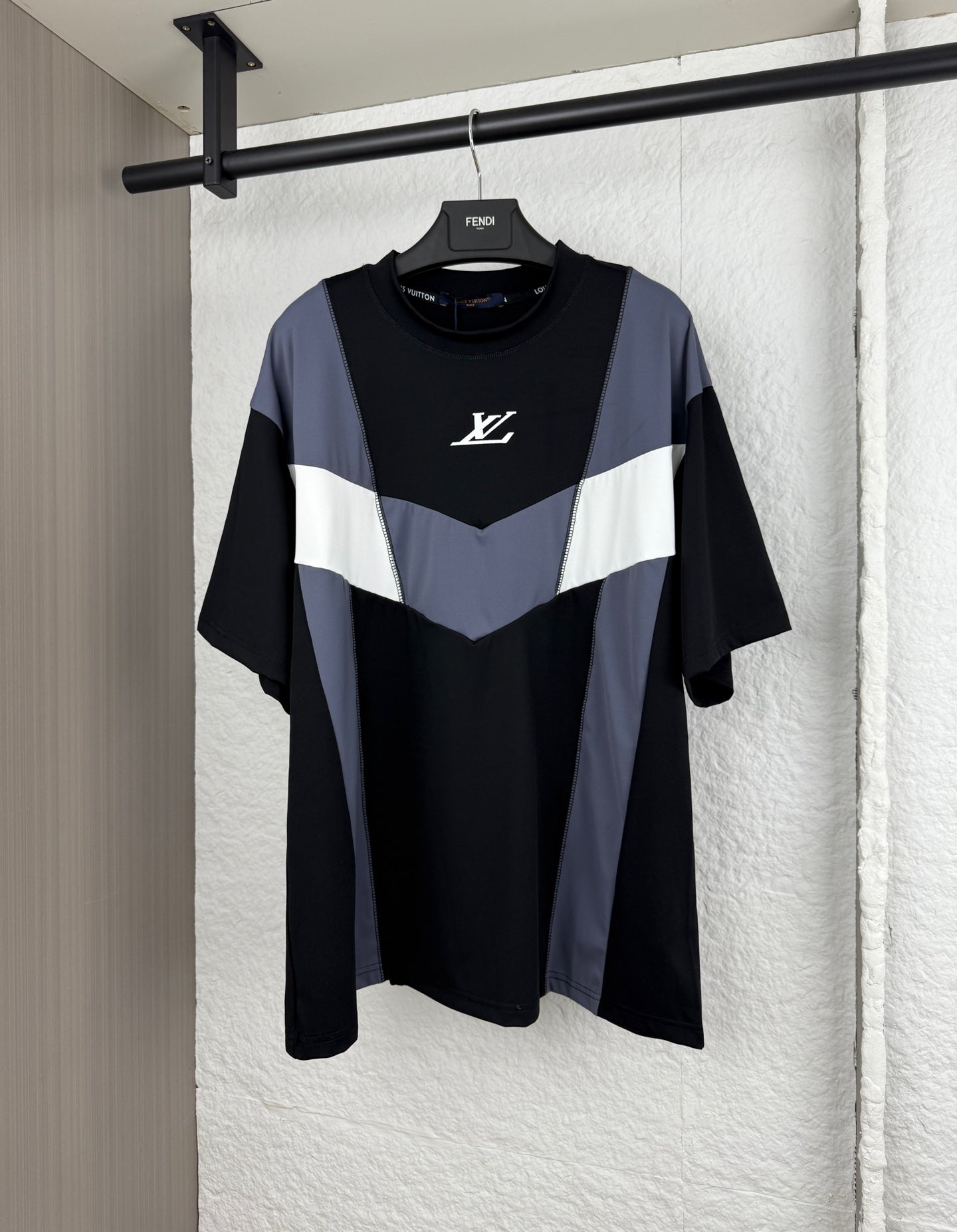 Louis Vuitton short-sleeve T-shirt with black body and blue/white chevron panel, logo on chest