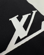 Louis Vuitton short-sleeve T-shirt close-up of white LV logo on black fabric