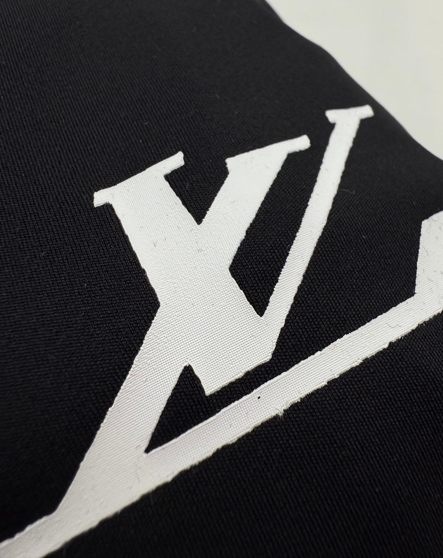 Louis Vuitton short-sleeve T-shirt close-up of white LV logo on black fabric