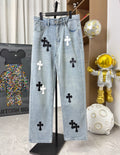 Light wash denim pants with black and white cross patches