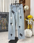 Light wash denim pants with black and white cross patches