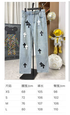 Light wash denim pants on display with black and white cross patches