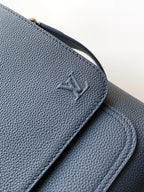 Louis Vuitton embossed logo on navy textured leather flap