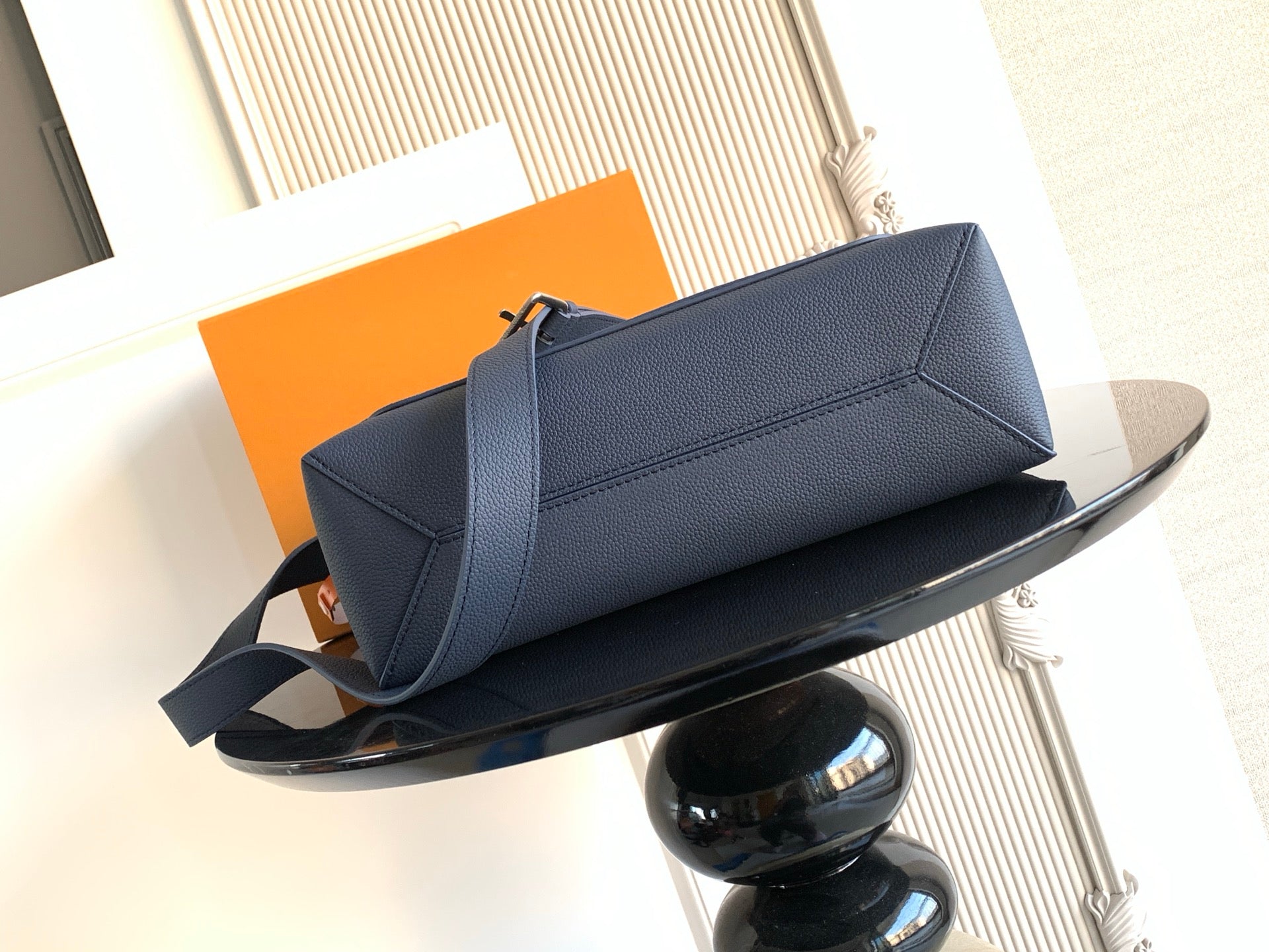 Louis Vuitton shoulder bag in navy textured leather with front flap and long strap