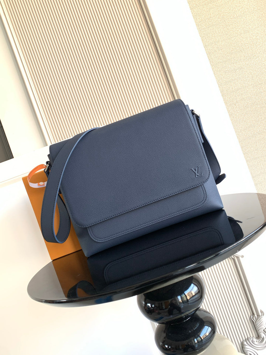 Louis Vuitton crossbody bag in navy textured leather, front flap with logo