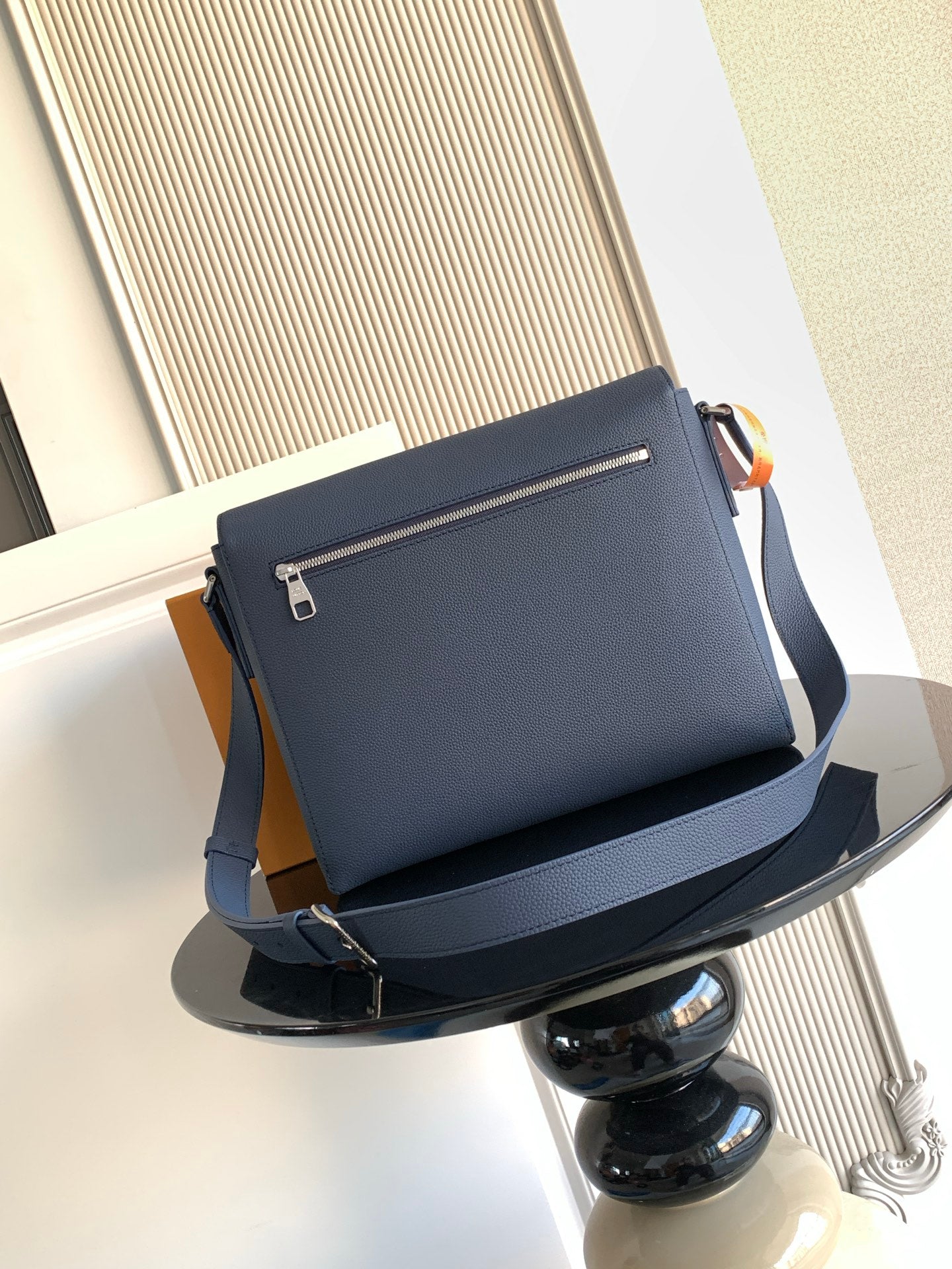 Louis Vuitton crossbody bag in navy textured leather with top zipper and shoulder strap