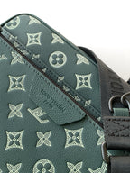 Louis Vuitton men's monogram bag in dark green, embossed pattern and zipper edge close-up