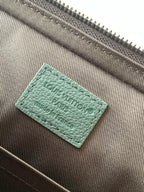 Louis Vuitton green leather label on brown interior lining fabric