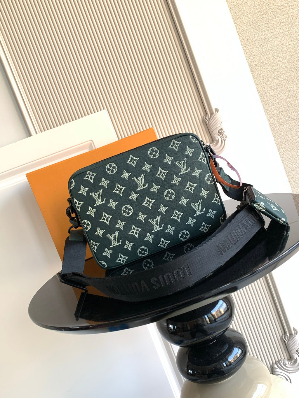 Louis Vuitton men's monogram shoulder bag in dark green, front view with adjustable strap