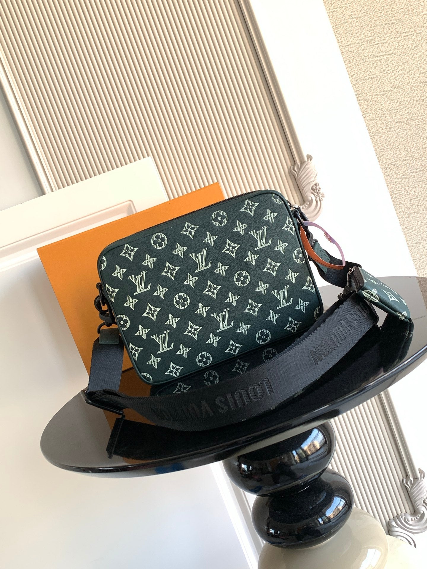 Louis Vuitton men's monogram shoulder bag in dark green, front view with adjustable strap