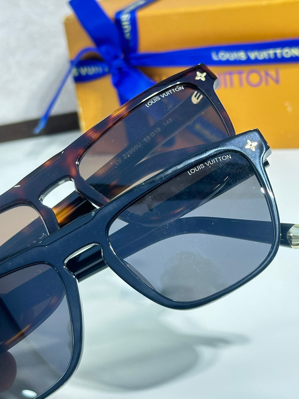 Louis Vuitton sunglasses, blue frame with gold star and LV logo on temples