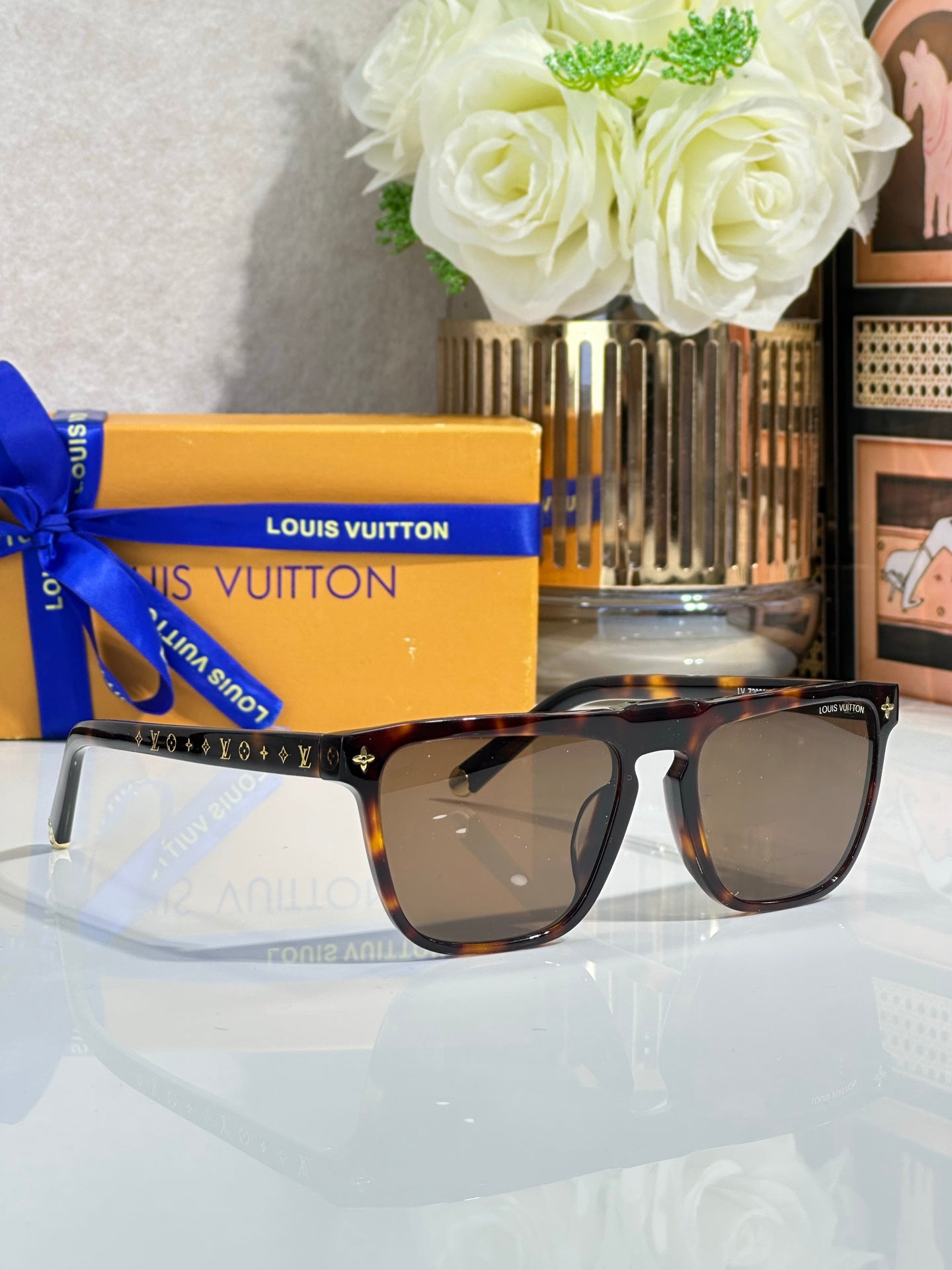 Louis Vuitton sunglasses, tinted lenses, tortoise-style frame with gold star accents