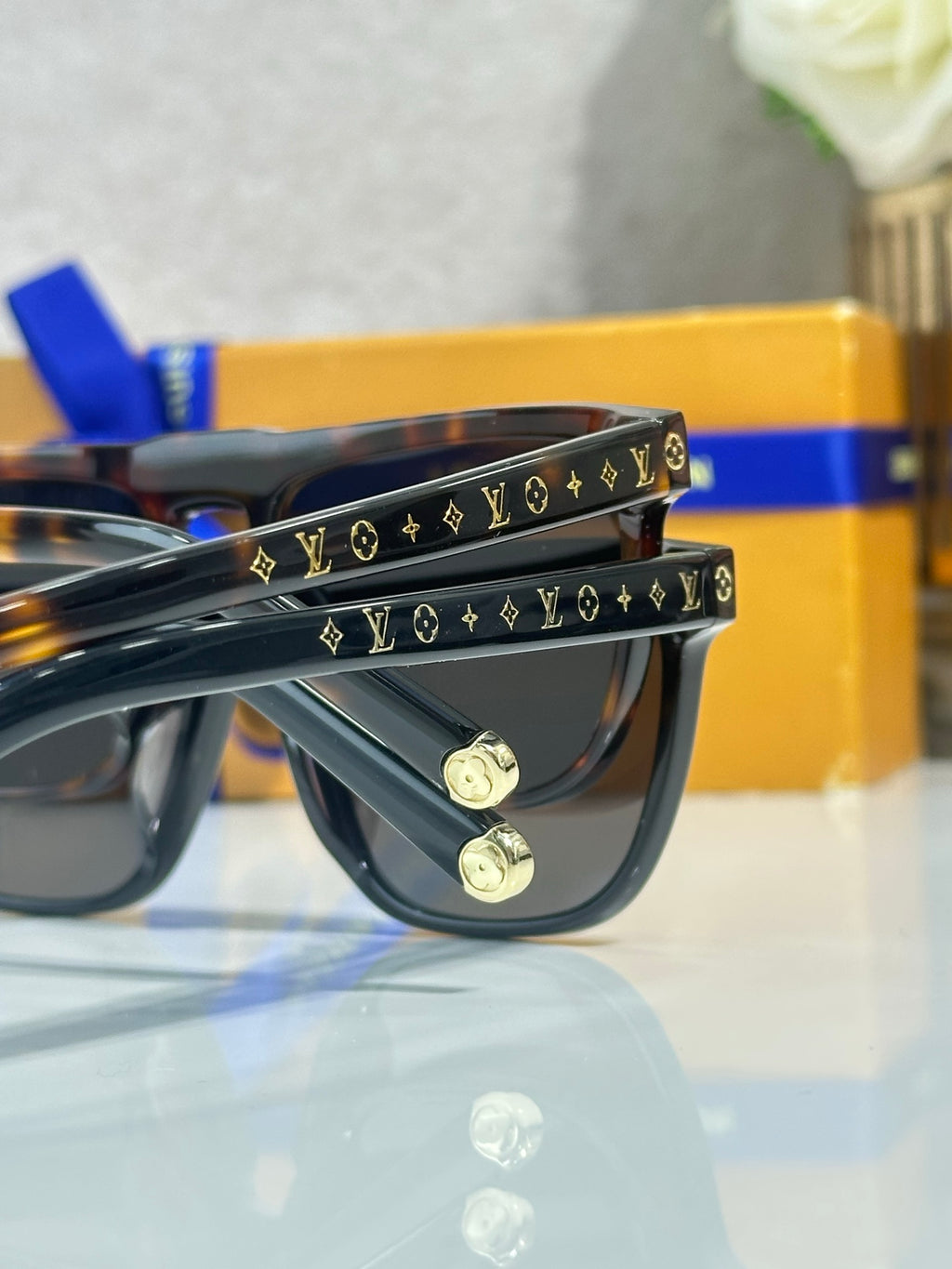 Louis Vuitton sunglasses, patterned temple bars with LV icons and gold-tone screws