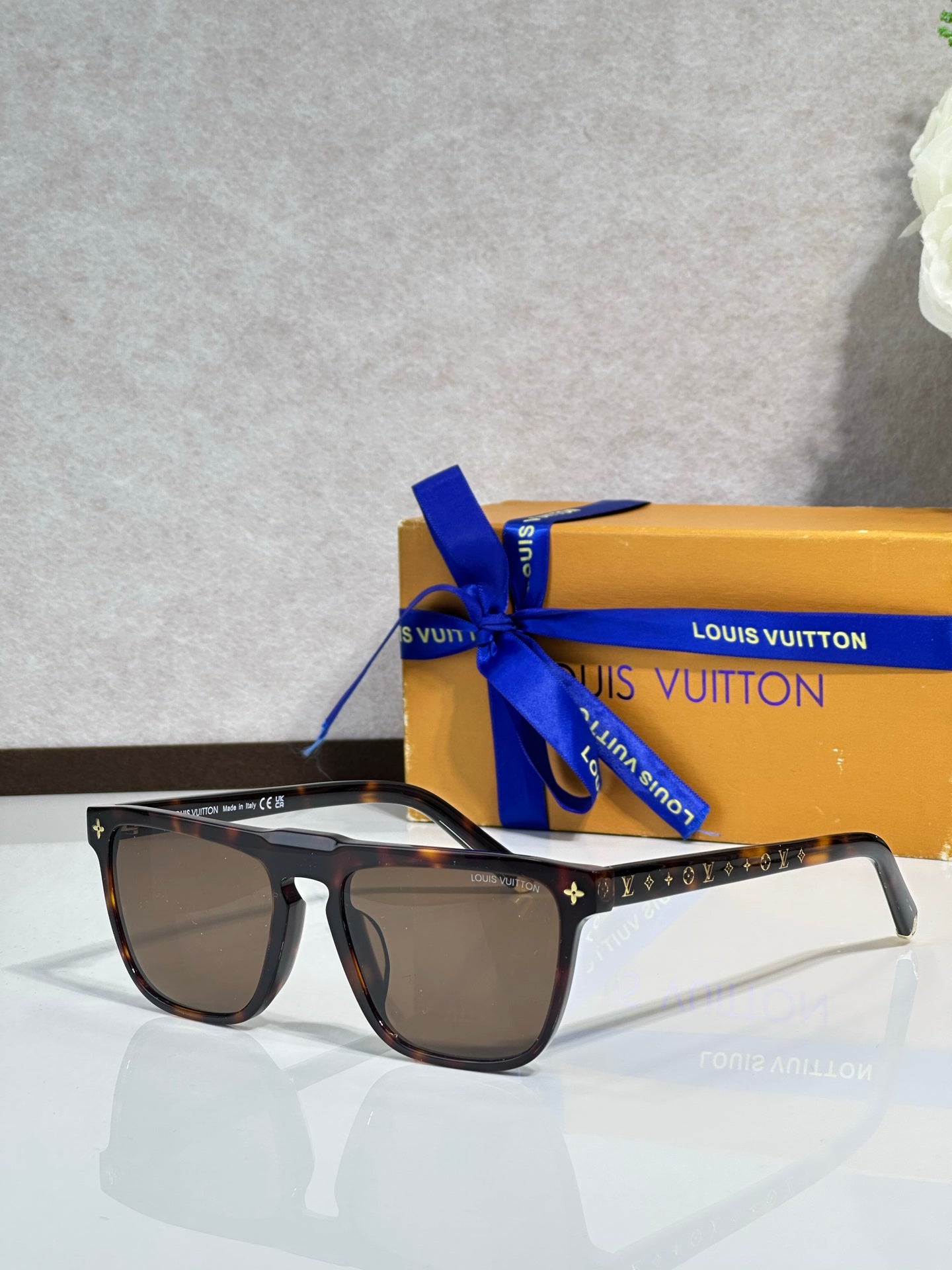 Louis Vuitton sunglasses, dark lenses, black frame with star motif and patterned temples