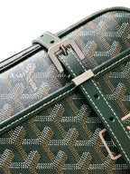 Green patterned bag close-up with front strap buckle and stitched crossbody handle