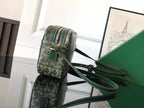 Green patterned crossbody bag with front flap and adjustable shoulder strap, zipper top