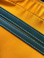 Green and orange bag interior leather label with stitched text and Made in France detail