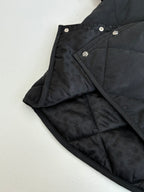 Black quilted jacket with snap details and patterned inner lining