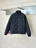 Black quilted long-sleeve jacket with snap-button front and stand collar