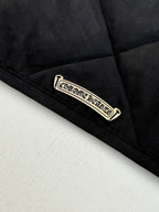 Black quilted jacket label patch near hem
