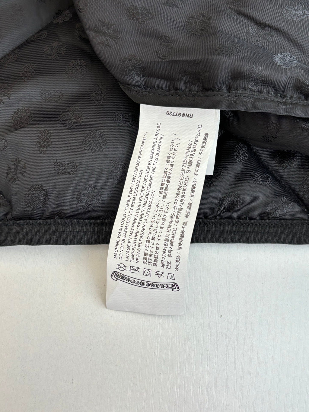Black jacket lining with white care label and subtle pattern