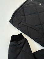 Black puffer jacket sleeve and side pocket with ribbed knit cuff