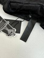 Black jacket interior with hang tag and care label
