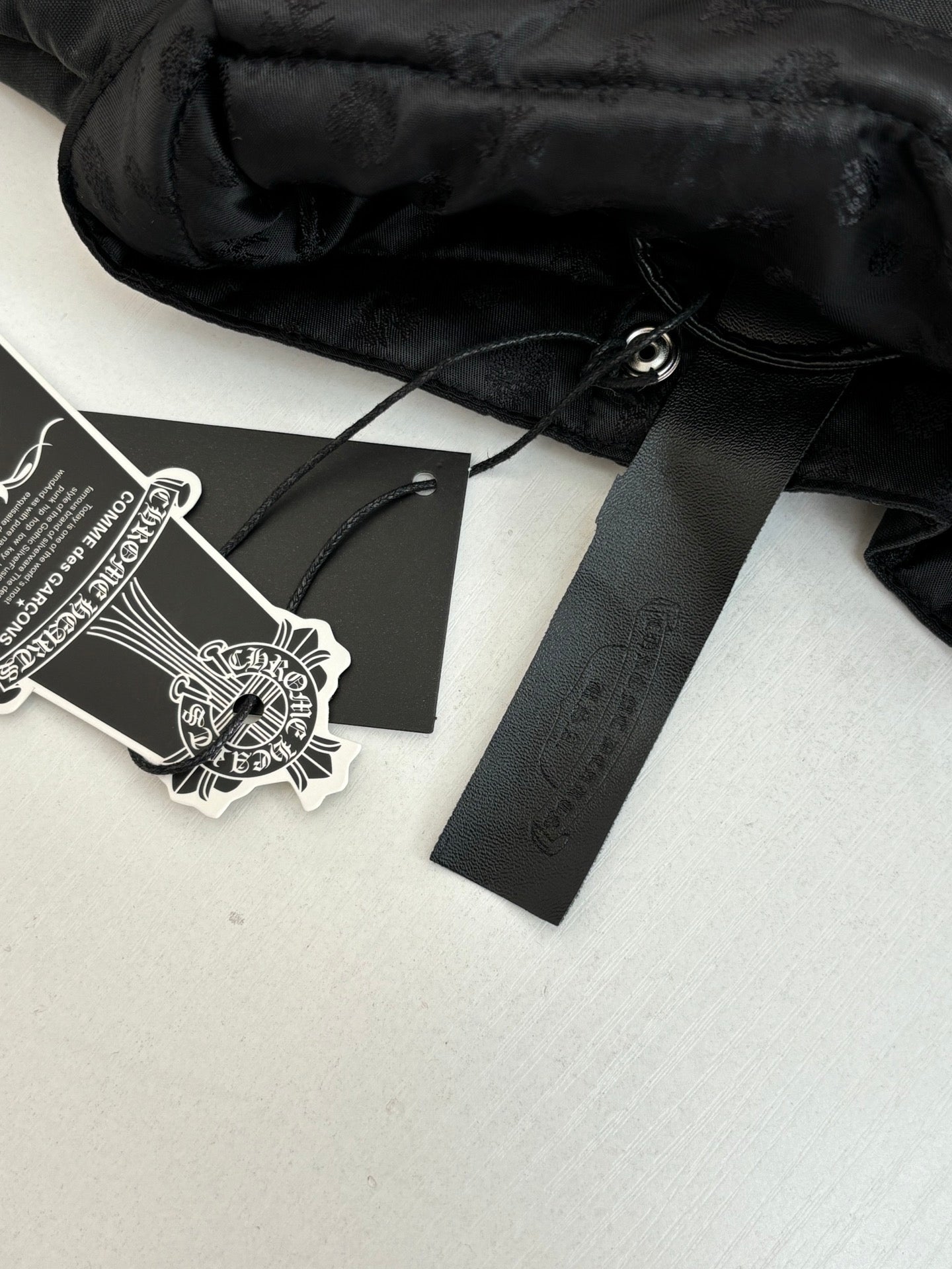 Black jacket interior with hang tag and care label