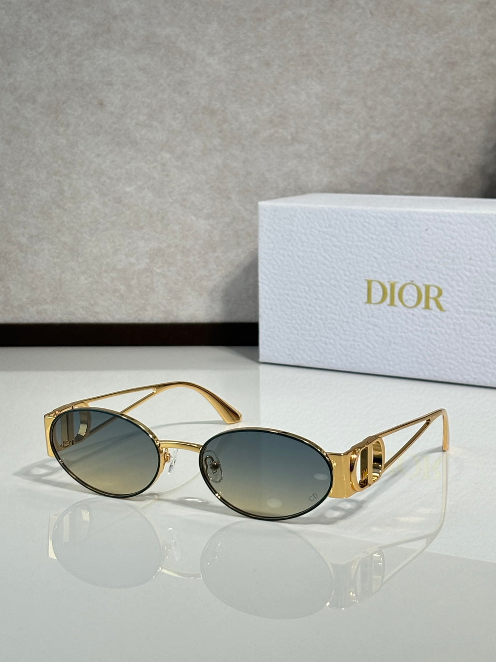 Gold-framed round sunglasses with smoky tinted lenses