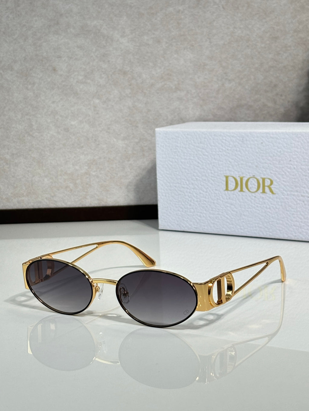 Gold-framed round sunglasses with dark tinted lenses