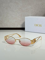Gold-framed round sunglasses with pink tinted lenses