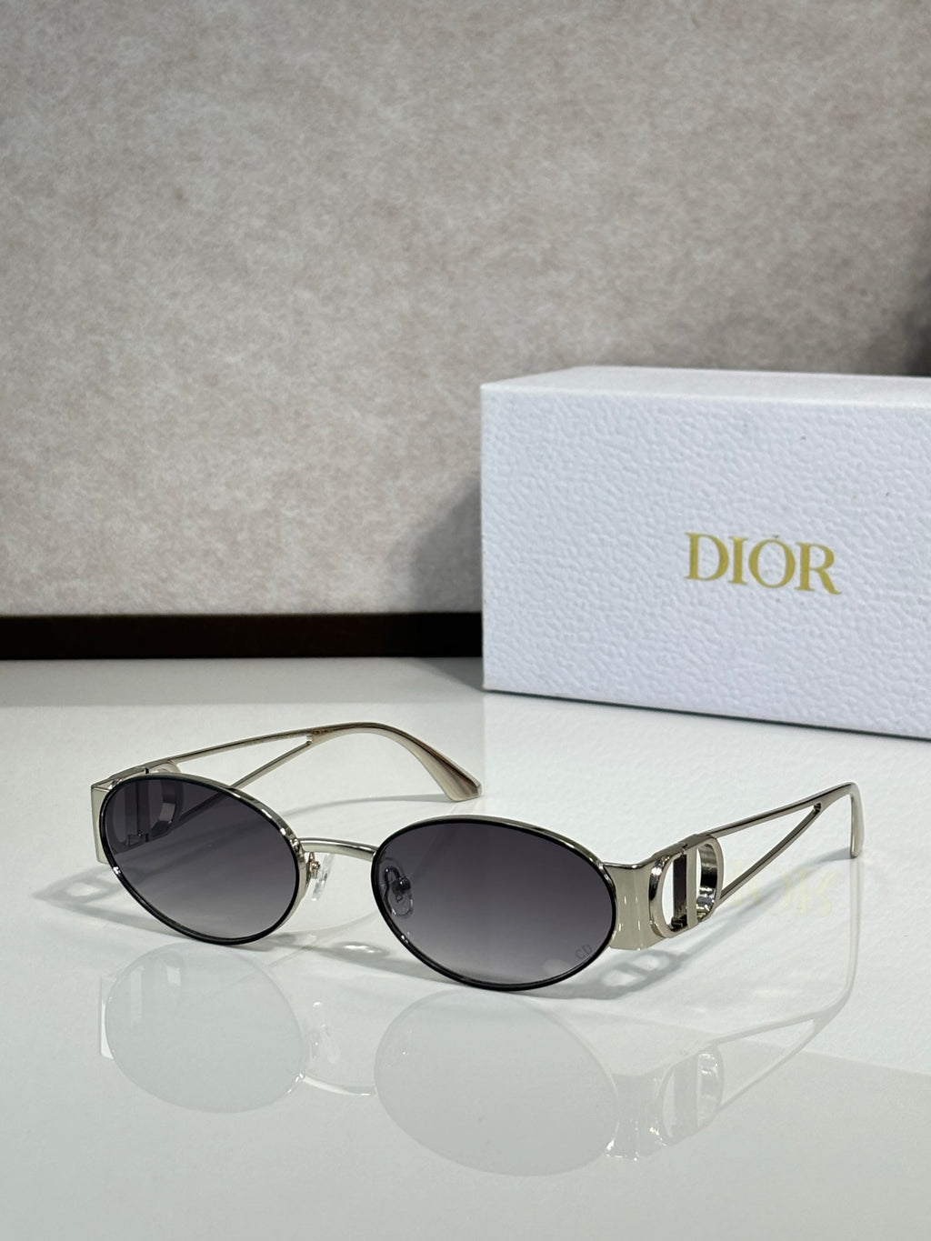 Gold-framed round sunglasses with dark tinted lenses