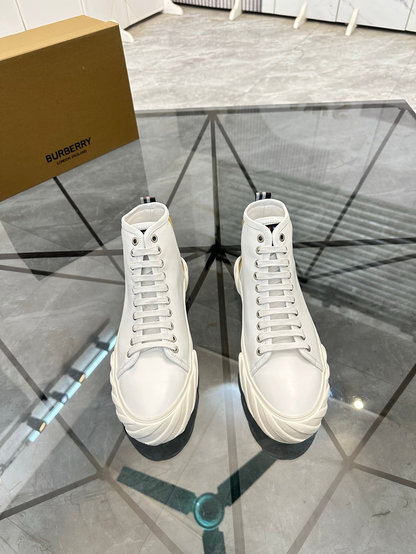 Burberry white high-top sneakers with lace-up front and padded collar