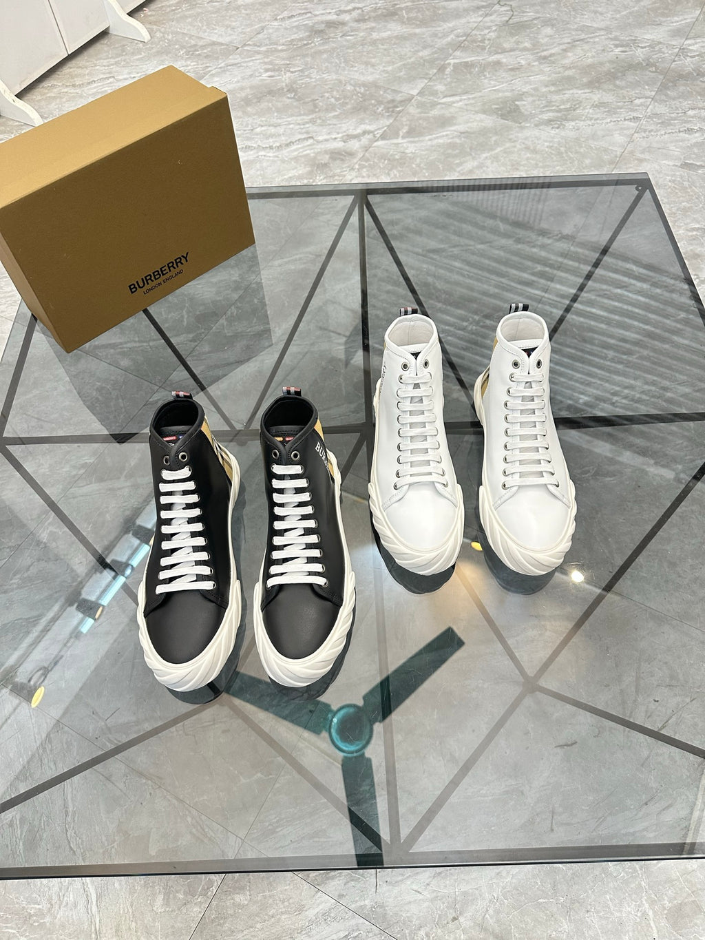 Burberry sneakers pair: white and black high-top lace-up styles