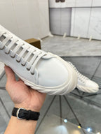 Burberry white leather high-top sneaker close-up of laces, side stitching, and toe