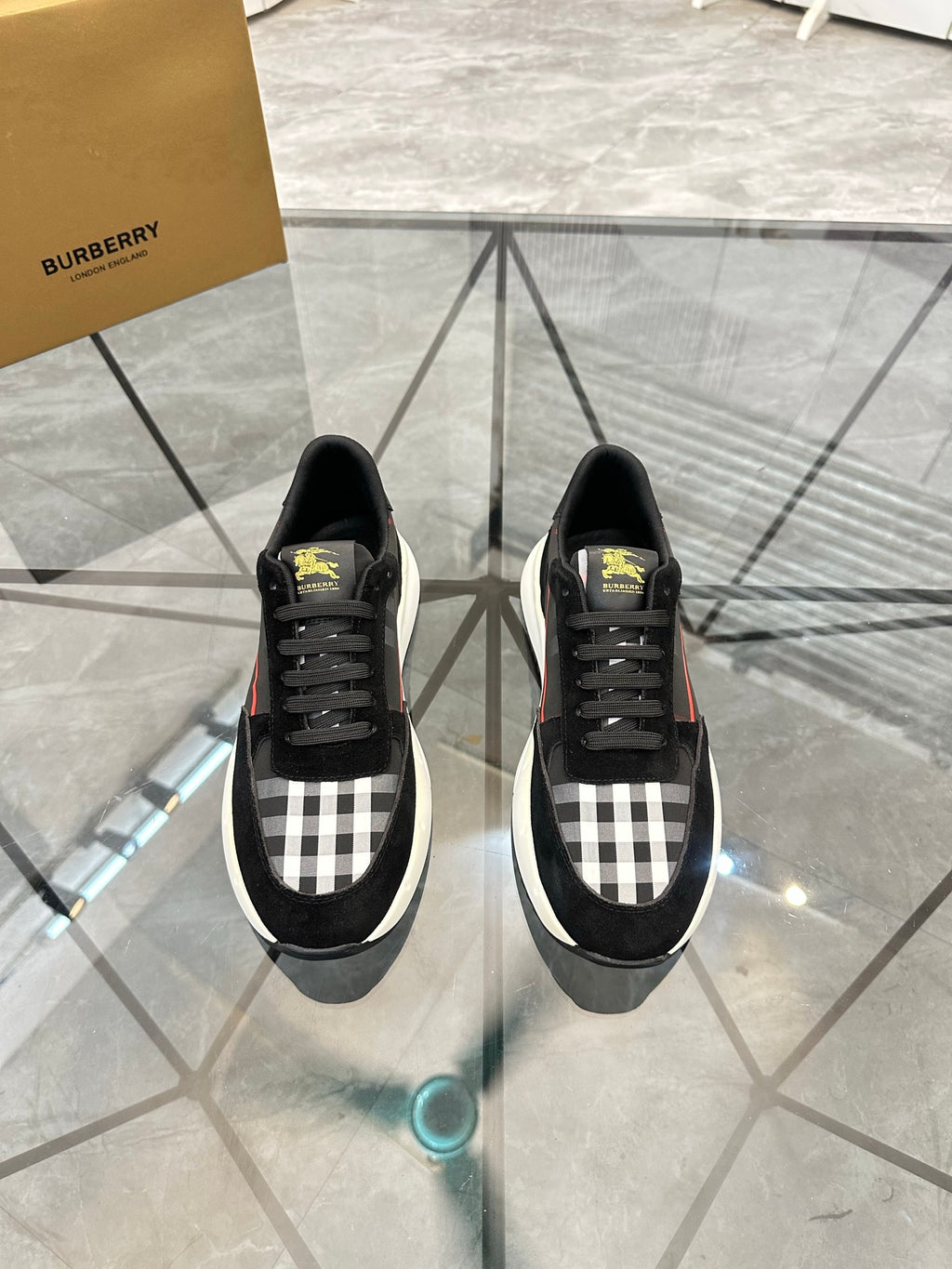 Burberry black lace-up sneakers with check panel, black toe, and chunky white sole