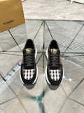 Burberry black lace-up sneakers with check panel, black toe, and chunky white sole