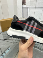 Burberry black sneaker with red and gray tartan stripe and thick white sole