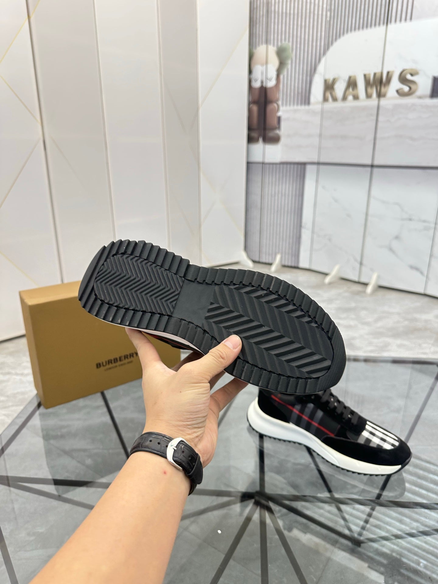Burberry sneaker outsole view with textured tread and stacked rubber sole