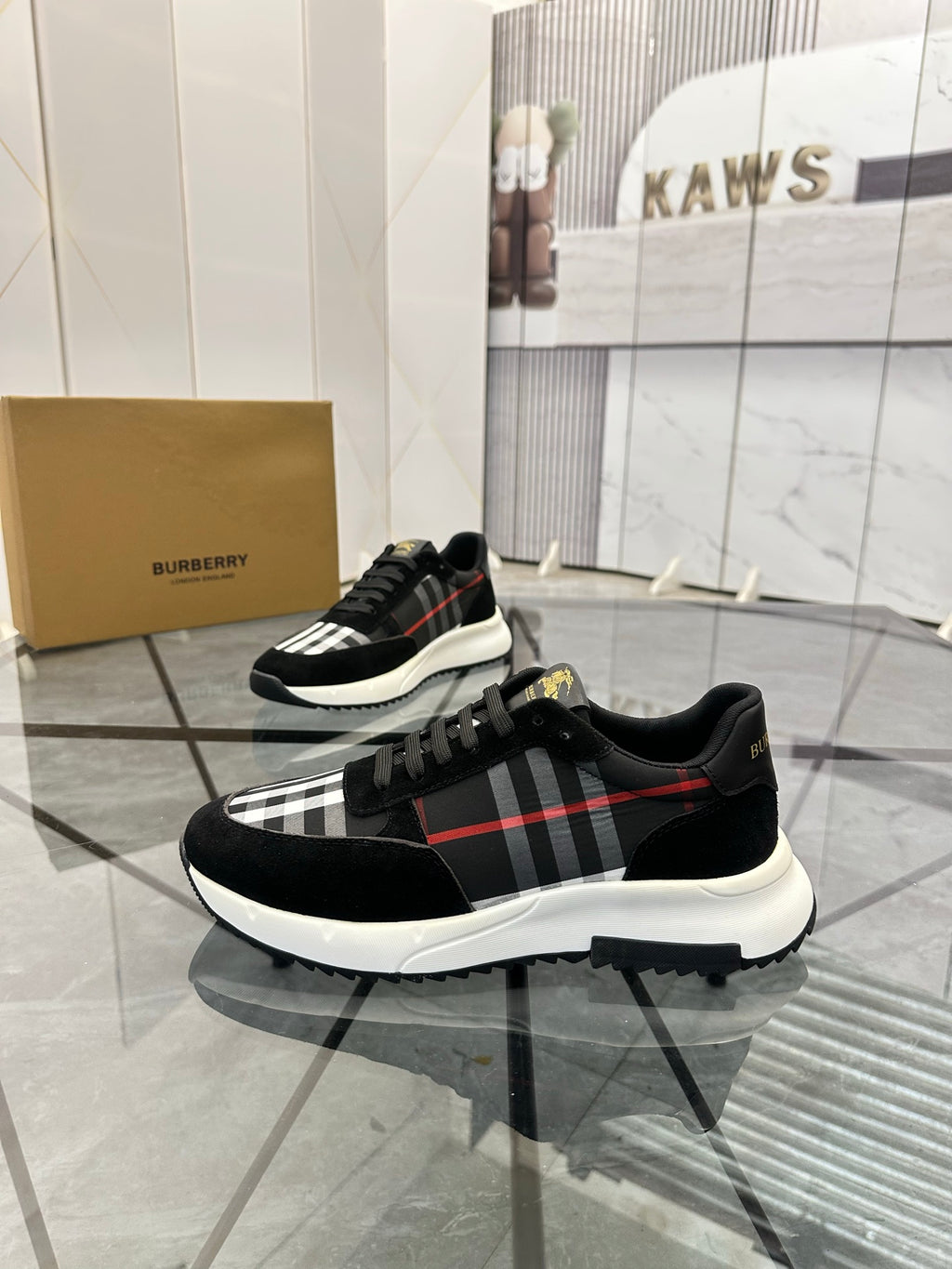Burberry black chunky sneakers with lace-up front and tartan panel across the side