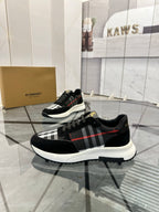 Burberry black chunky sneakers with lace-up front and tartan panel across the side