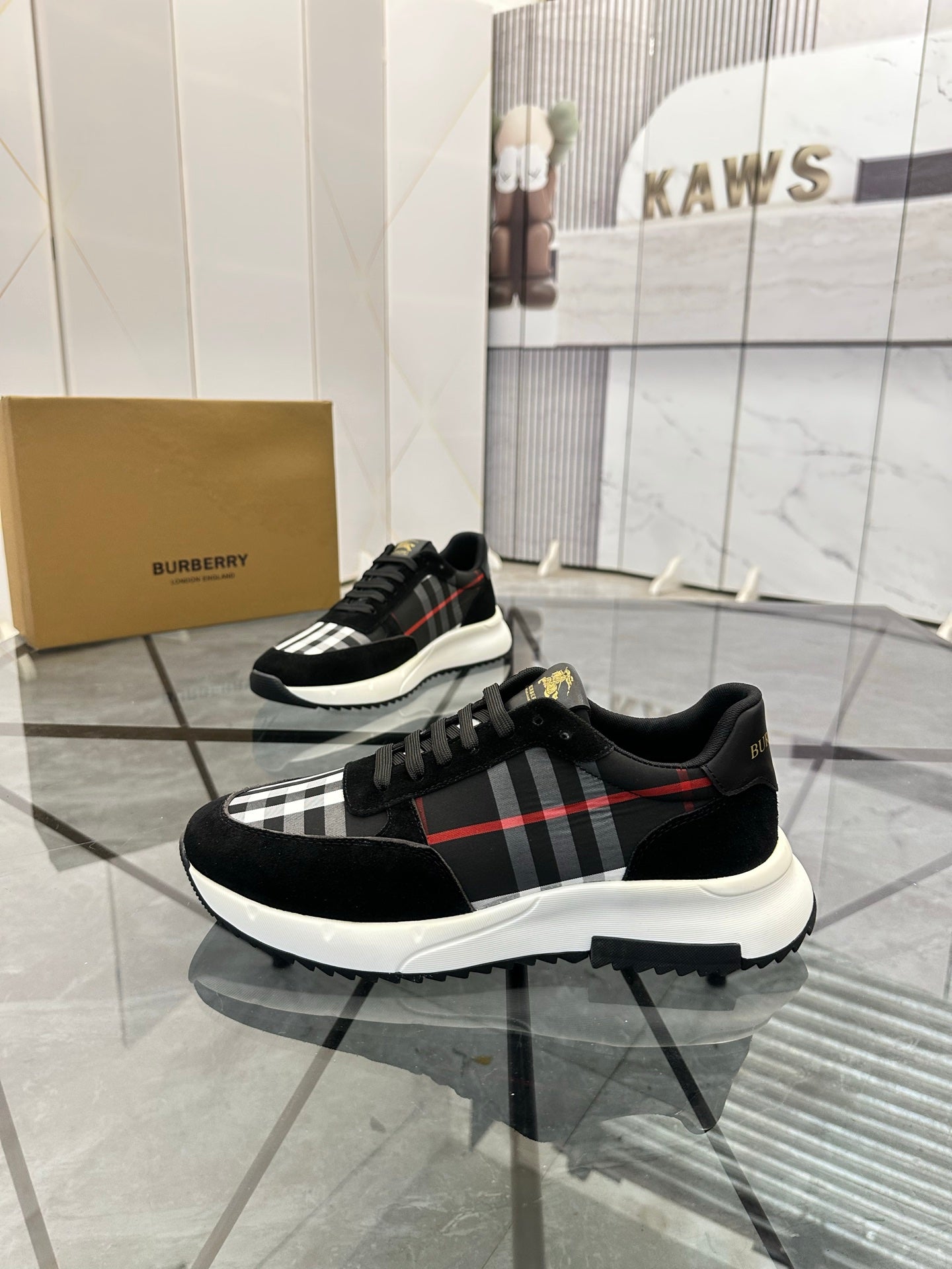 Burberry black chunky sneakers with lace-up front and tartan panel across the side