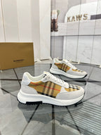 Pair of white lace-up sneakers with tan plaid panel details and chunky rubber sole