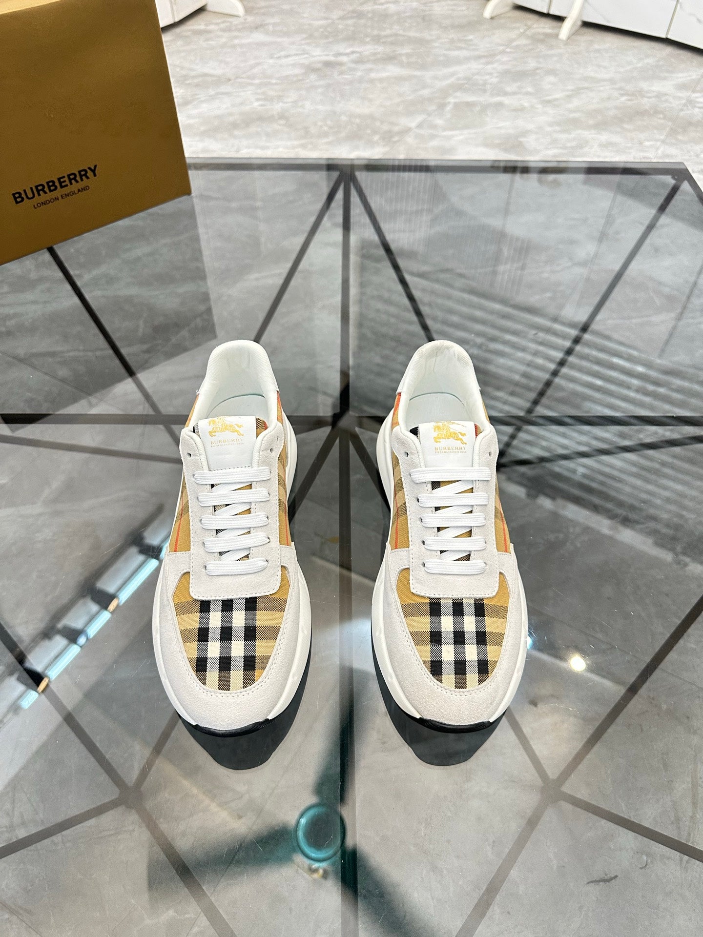 White low-top sneakers with plaid quarter panel, lace-up, black trim, rubber sole