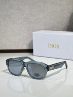 Dior sunglasses with black frames and blue-gray lenses, gold hinge detail