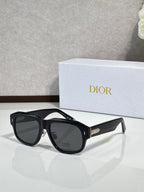 Dior sunglasses with oversized black frames and dark lenses, gold detail at temple