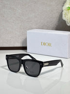 Dior sunglasses with black square frames and dark lenses, broad rectangular brow profile